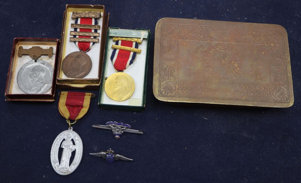 A WWII tobacco tin and medals
